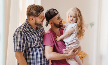 Adoptive Fathers holding adopted Daughter