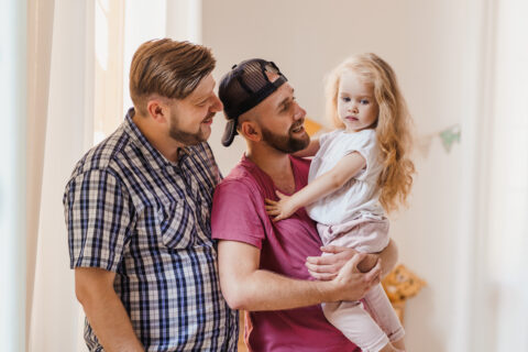 Adoptive Fathers holding adopted Daughter